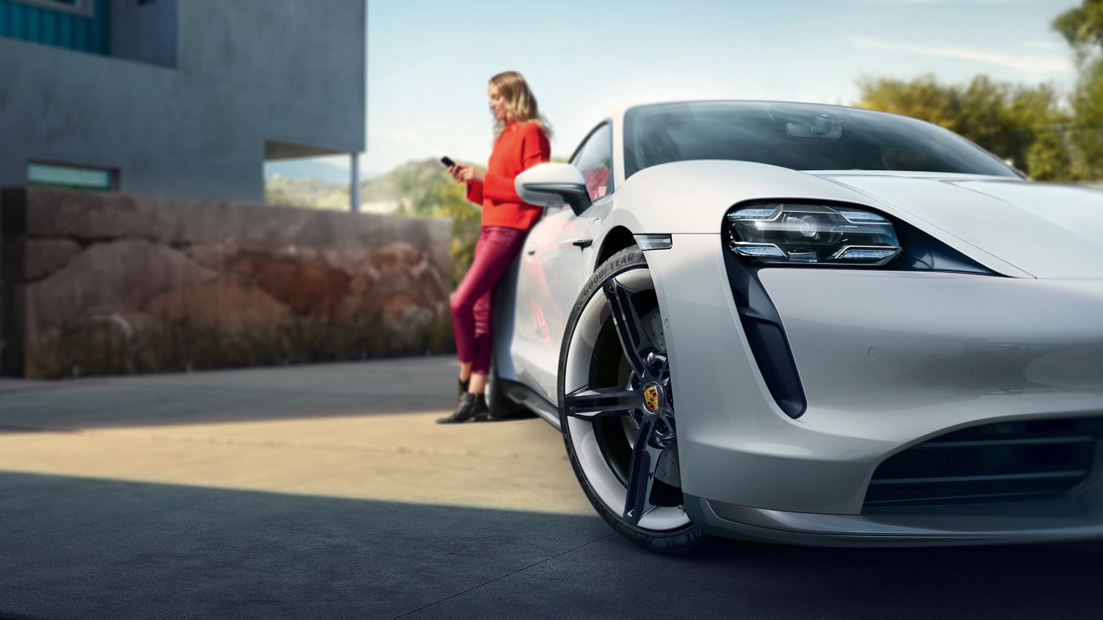 woman next to Porsche Taycan